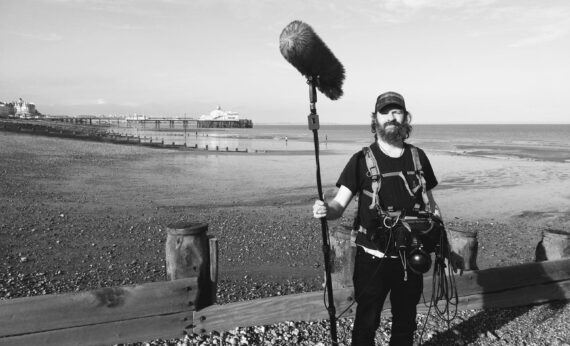 Len on location by the coast